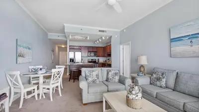 a living room with a couch and a table at Laketown Wharf #2025 in Panama City Beach