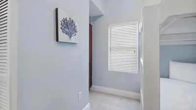 a bedroom with a bed and a window at Laketown Wharf #2025 in Panama City Beach