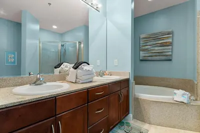 a bathroom with two sinks and a tub at Laketown Wharf 2032 in Panama City Beach