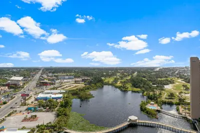 a view of a river with a bridge and a city at Laketown Wharf 2032 in Panama City Beach