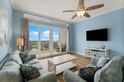 a living room with a couch and a flat screen tv at Laketown Wharf 2032 in Panama City Beach