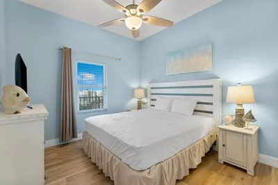 a bedroom with a white bed and a ceiling fan at Laketown Wharf 2032 in Panama City Beach