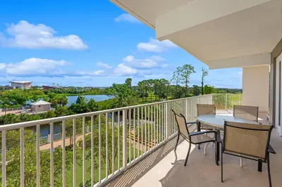 a balcony with a table and chairs and a view at Laketown Wharf #0201 in Panama City Beach