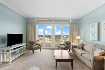 a living room with a couch and a tv at Laketown Wharf #2133 in Panama City Beach