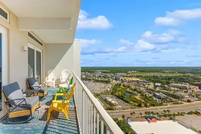 a balcony with chairs and a view of a city at Laketown Wharf #2030 in Panama City Beach