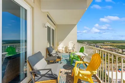 a balcony with chairs and tables and a view at Laketown Wharf #2030 in Panama City Beach
