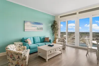 a living room with a blue couch and chairs at Laketown Wharf #2030 in Panama City Beach