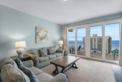 a living room with a couch and a table at Laketown Wharf #0811 in Panama City Beach