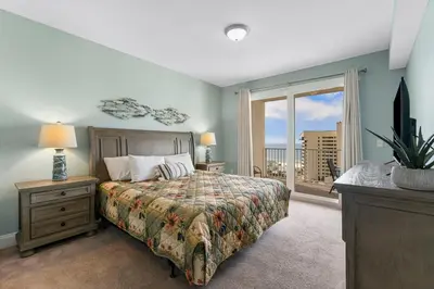 a bedroom with a bed and a large window at Laketown Wharf #0811 in Panama City Beach
