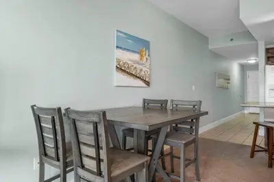 a dining room with a wooden table and chairs at Laketown Wharf #0811 in Panama City Beach