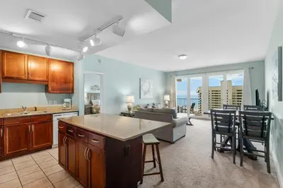 a kitchen and living room with a view of the ocean at Laketown Wharf #0811 in Panama City Beach