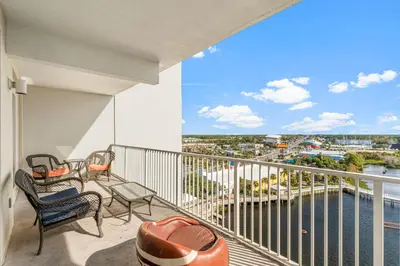a balcony with chairs and a view of the water at Laketown Wharf #0932 in Panama City Beach