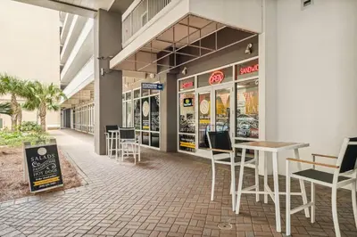a restaurant with tables and chairs in a building at Laketown Wharf #0932 in Panama City Beach