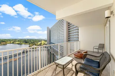 a balcony with chairs and a view of the water at Laketown Wharf #0932 in Panama City Beach