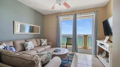 a living room with a couch and a flat screen tv at Grand Panama #1-1705 in Panama City Beach
