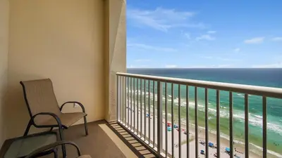 a balcony with a chair and a view of the ocean at Grand Panama #1-1705 in Panama City Beach