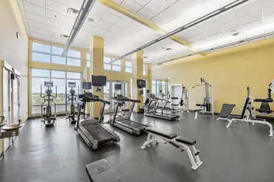 a gym with several treadmills and cardio machines at Grand Panama #1-1207 in Panama City Beach
