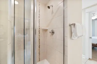 a shower with a glass door in a bathroom at Grand Panama #1-1207 in Panama City Beach
