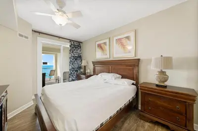 a bedroom with a bed and a ceiling fan at Grand Panama #1-1207 in Panama City Beach