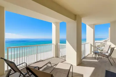 a balcony with chairs and a view of the ocean at Grand Panama #1-1001 in Panama City Beach