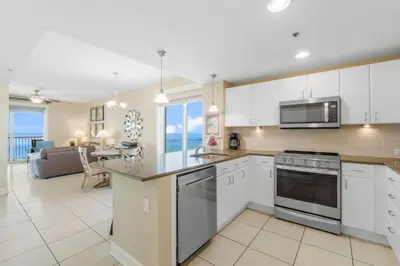 a kitchen with white cabinets and a counter top at Grand Panama #1-1001 in Panama City Beach