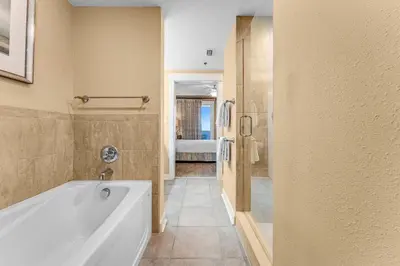 a bathroom with a tub and a walk in shower at Grand Panama #1-1704 in Panama City Beach