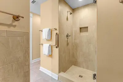 a bathroom with a shower with a glass door at Grand Panama #1-1704 in Panama City Beach