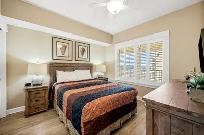 a bedroom with a large bed and a window at Grand Panama #1-1704 in Panama City Beach