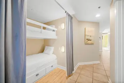 a room with two bunk beds and a hallway at Grand Panama #1-1704 in Panama City Beach