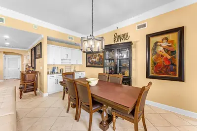 a kitchen and dining room with a table and chairs at Grand Panama #1-2201 in Panama City Beach