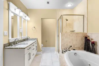 a bathroom with two sinks and a tub and a shower at Grand Panama #1-2201 in Panama City Beach