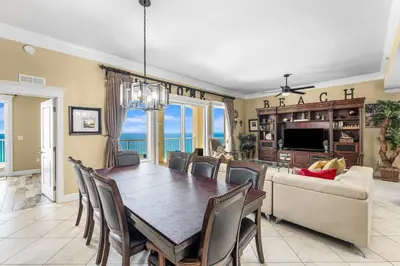 a dining room with a table and a couch at Grand Panama #1-2201 in Panama City Beach