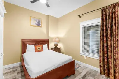 a bedroom with a bed and a window at Grand Panama #1-2201 in Panama City Beach