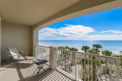 a balcony with a chair and a view of the ocean at Grand Panama #1-0408 in Panama City Beach