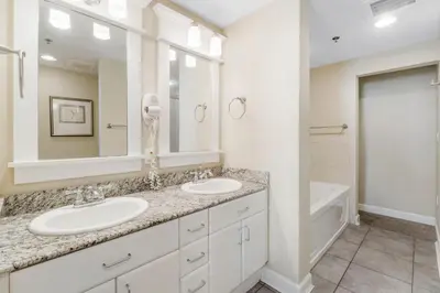 a white bathroom with two sinks and a bath tub at Grand Panama #1-0408 in Panama City Beach