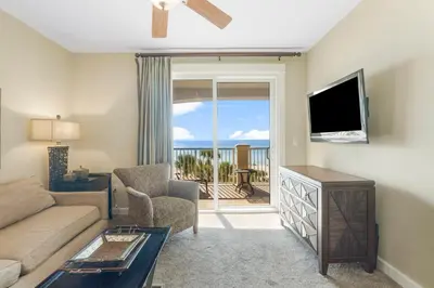 a living room with a couch and a flat screen tv at Grand Panama #1-0408 in Panama City Beach