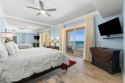a bedroom with a bed and a flat screen tv at Grand Panama #1-2101 in Panama City Beach