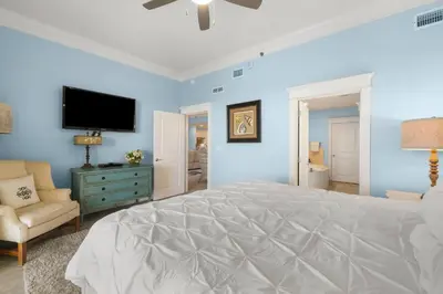 a bedroom with a large bed and a tv at Grand Panama #1-2101 in Panama City Beach