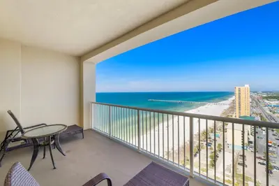 a balcony with a table and chairs and the ocean at Grand Panama #1-2101 in Panama City Beach