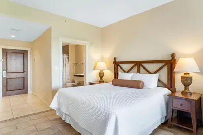 a bedroom with a large white bed and two lamps at Origin #1215 in Panama City Beach
