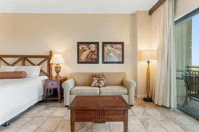 a bedroom with a bed and a couch and a table at Origin #1215 in Panama City Beach