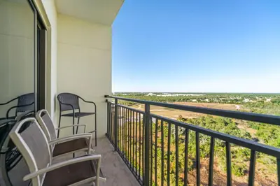 two chairs sitting on a balcony with a view at Origin #1215 in Panama City Beach