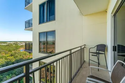 a balcony with a chair and a view of the ocean at Origin #1215 in Panama City Beach