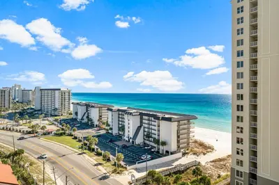 a view of the beach from the balcony of a building at Grand Panama #2-0603 in Panama City Beach