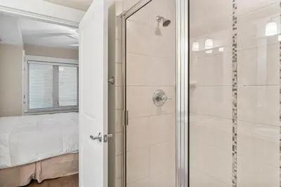a bathroom with a shower with a glass door at Grand Panama #2-0603 in Panama City Beach