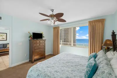 a bedroom with a bed and a window with the ocean at Shores Of Panama #1412 in Panama City Beach