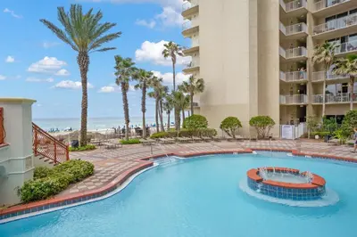 a swimming pool at a resort with palm trees at Shores Of Panama #1412 in Panama City Beach
