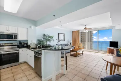 an open kitchen and living room with a view of the ocean at Shores Of Panama #1412 in Panama City Beach