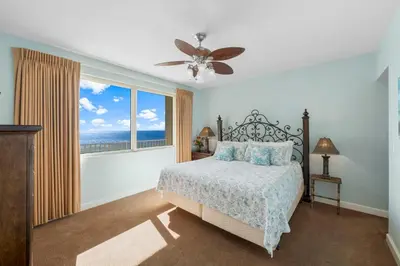 a bedroom with a bed and a large window at Shores Of Panama #1412 in Panama City Beach