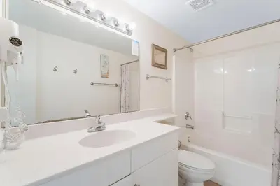 a white bathroom with a sink and a toilet at Shores Of Panama #1205 in Panama City Beach